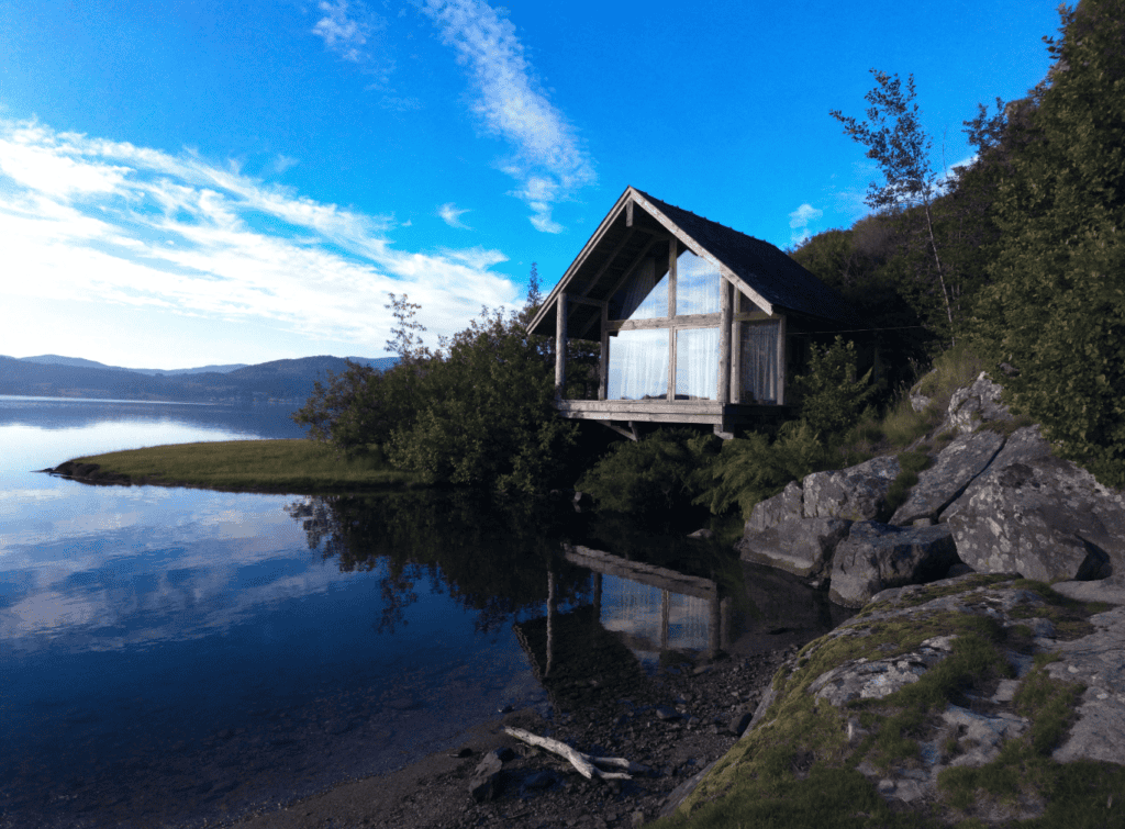 A-Frame Cabin Small Home - Small Homes USA Newsletter Cozy small lakeside cabin with large windows and scenic mountain view.