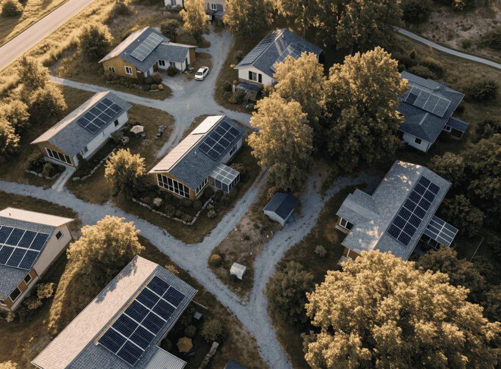 Aerial View - Small Homes USA Newsletter Aerial view of small homes with solar panels in a green neighborhood.