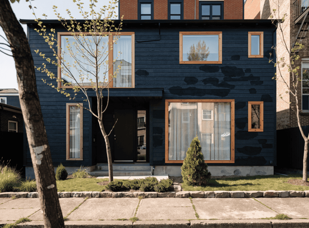 Bright Modern Small Home - Small Homes USA Newsletter Modern small home with black exterior and large windows, urban setting.
