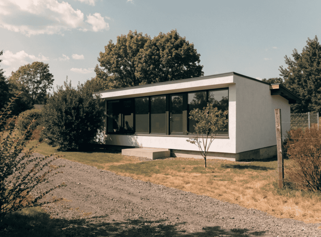 Clean Lines Small Home - Small Homes USA Newsletter Modern small home with large windows and minimalist design in a natural setting.