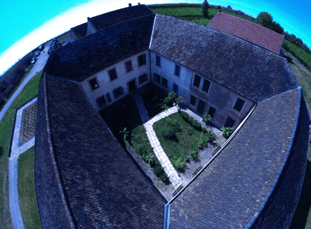 Historic Courtyard Building - Small Homes USA Newsletter Aerial view of a historic courtyard building with garden and pathways.