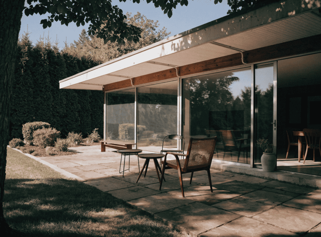 Flat Roof - Small Homes USA Newsletter Modern small home with large glass windows and outdoor patio area.