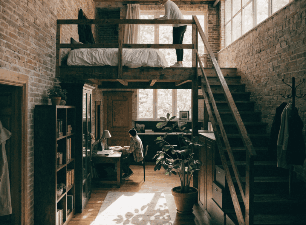 Loft Style - Small Homes USA Newsletter Cozy loft with workspace and sleeping area in a rustic home.