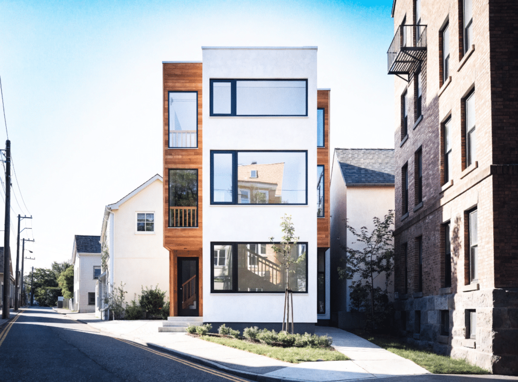 Modern three-story narrow infill home - Small Homes USA Newsletter Modern three-story narrow infill home with wood and white exterior on an urban lot.