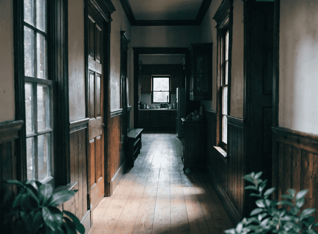 Shogun Style - Small Homes USA Newsletter Vintage wooden hallway with natural light and potted plants.