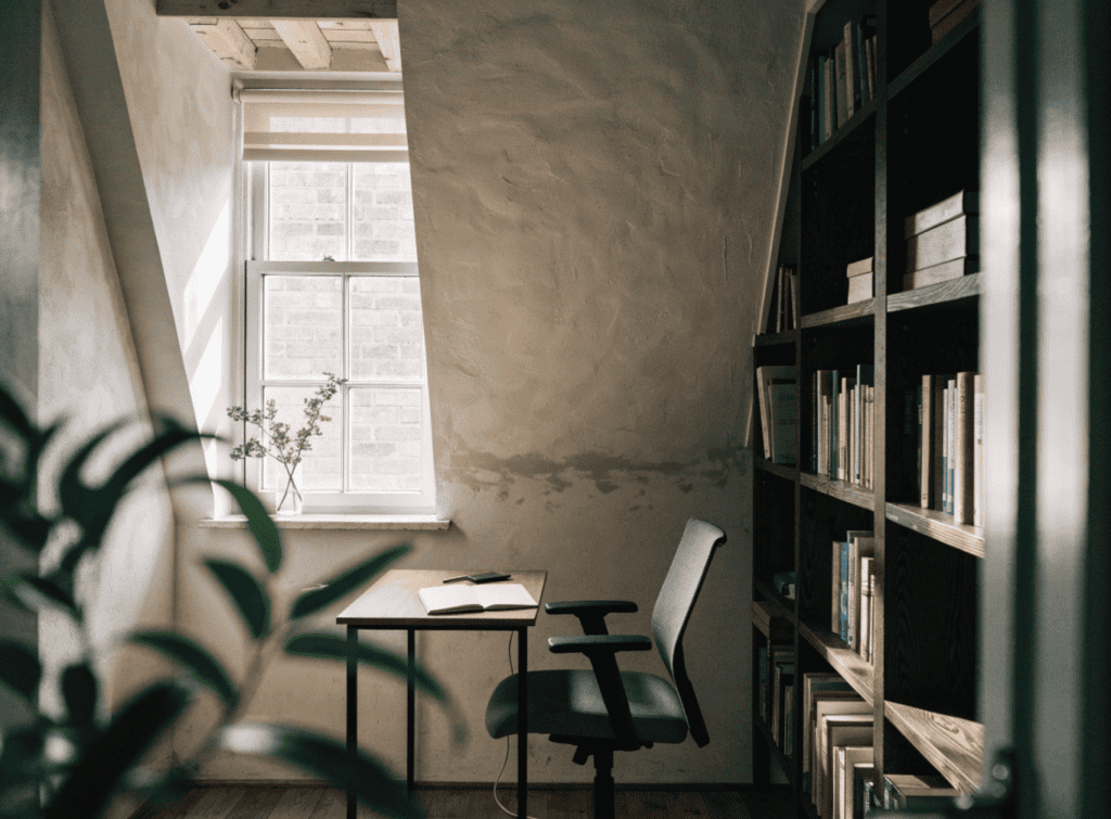 Tiny Loft Office - Small Homes USA Newsletter Cozy home office with a window, bookshelf, and desk in a tiny house loft.